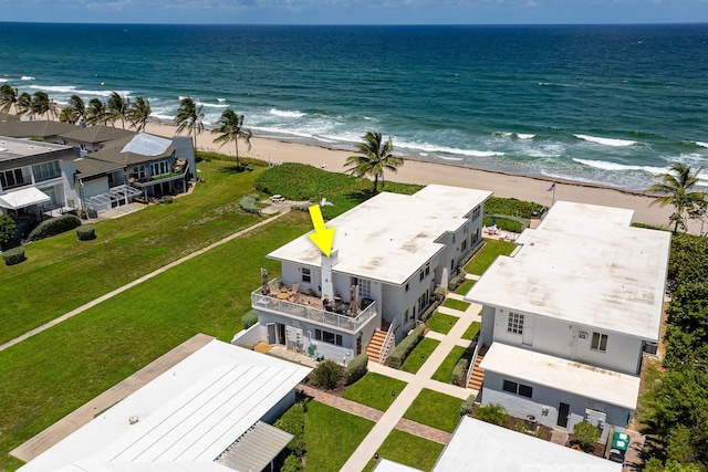 birds eye view of property featuring a beach view and a water view