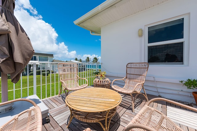 wooden deck with a lawn