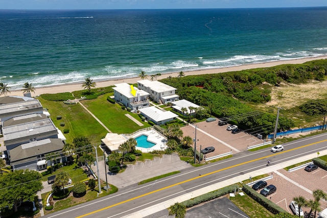 drone / aerial view featuring a beach view and a water view