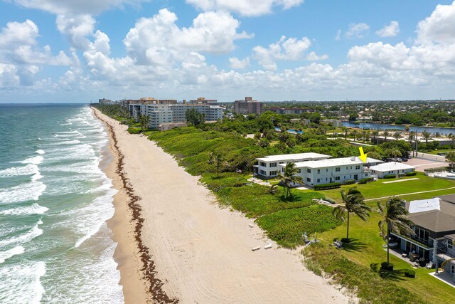 birds eye view of property featuring a beach view and a water view