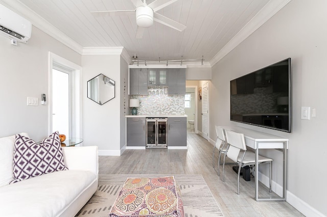 living room with ceiling fan, beverage cooler, hardwood / wood-style floors, rail lighting, and crown molding