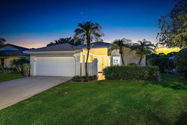 view of front of house featuring a yard and a garage