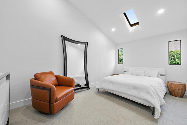 bedroom with carpet flooring, high vaulted ceiling, and a skylight