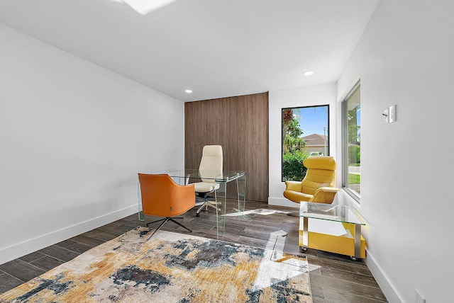 home office with dark hardwood / wood-style flooring