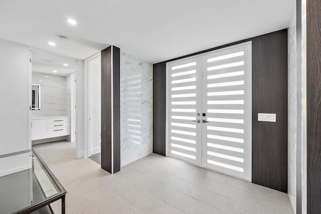 hallway with light tile patterned floors and french doors