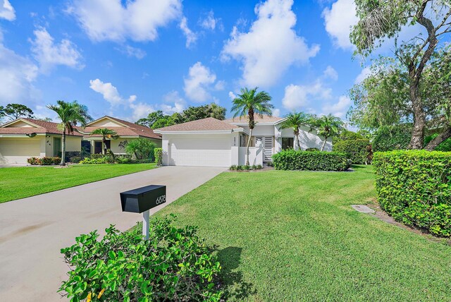 view of front facade featuring a front lawn and a garage