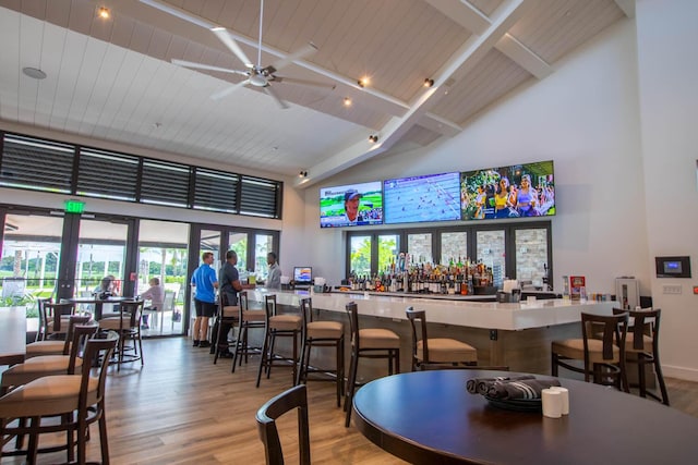 bar with hardwood / wood-style flooring, wood ceiling, high vaulted ceiling, and beamed ceiling