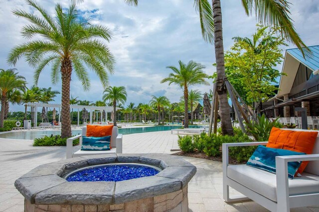 view of patio / terrace with a swimming pool with hot tub