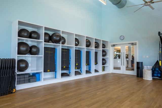 workout area featuring wood-type flooring, french doors, and ceiling fan