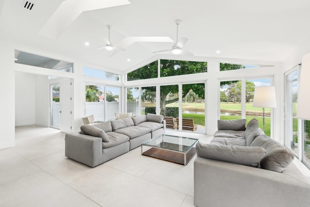 interior space with ceiling fan, a water view, vaulted ceiling, and plenty of natural light