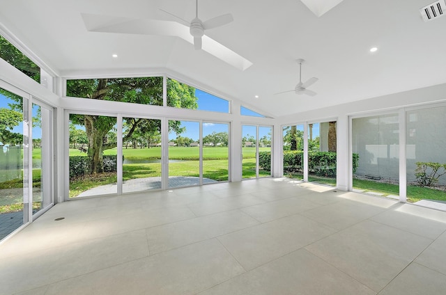 unfurnished sunroom featuring ceiling fan, a skylight, and a wealth of natural light