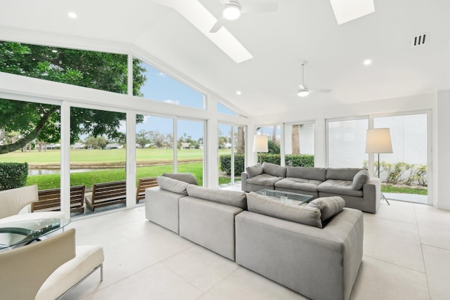 sunroom featuring ceiling fan, a wealth of natural light, and vaulted ceiling with skylight