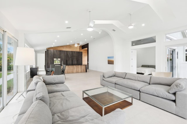 living room with wooden walls, high vaulted ceiling, and plenty of natural light