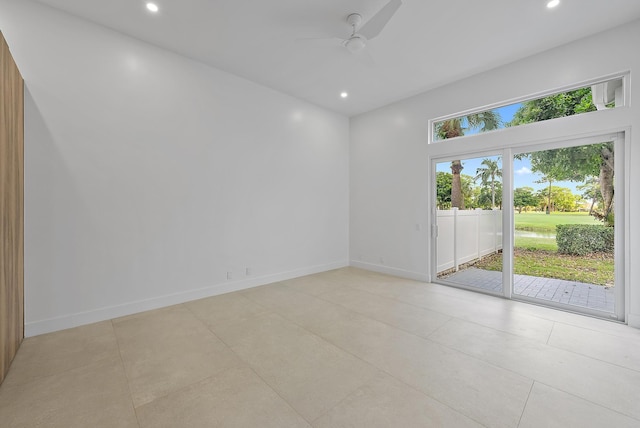 empty room featuring ceiling fan and light tile patterned floors