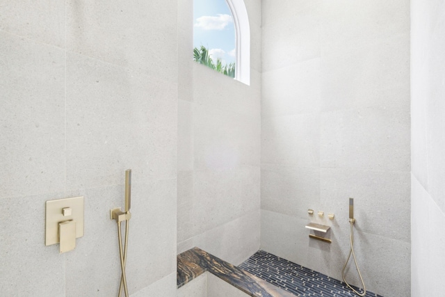 bathroom with a tile shower