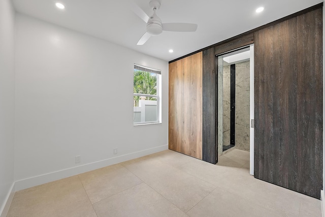 unfurnished bedroom with ceiling fan and light tile patterned floors