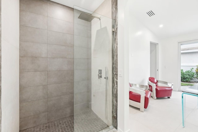 bathroom featuring tiled shower and vaulted ceiling