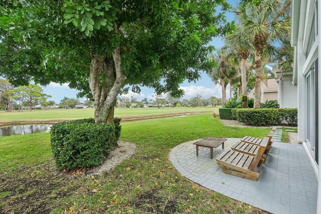 view of yard with a patio and a water view