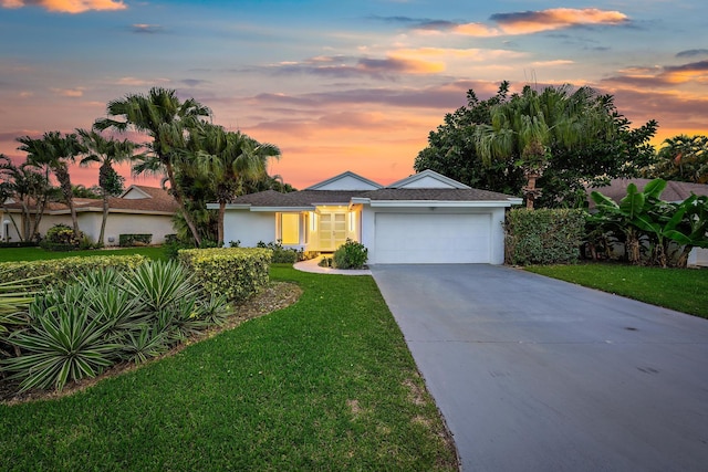 single story home with a lawn and a garage