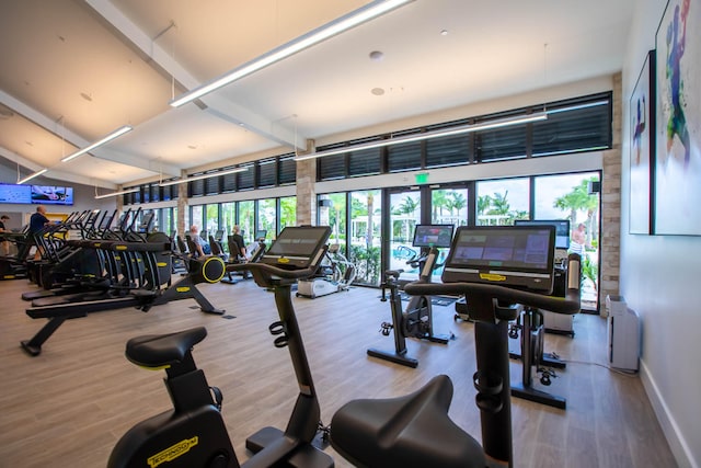 workout area featuring hardwood / wood-style flooring and radiator heating unit