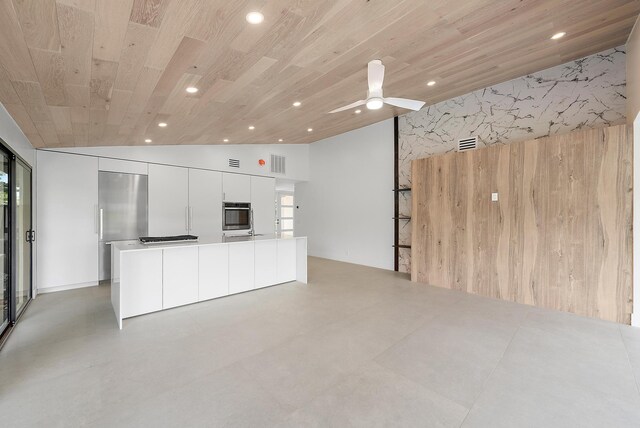 unfurnished living room featuring wooden ceiling, high vaulted ceiling, wooden walls, and ceiling fan