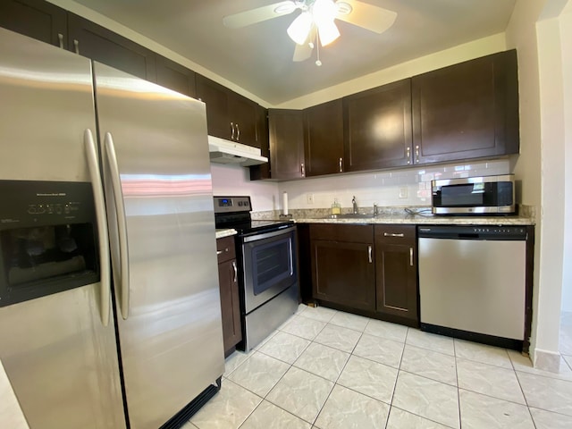 kitchen featuring dark brown cabinets, appliances with stainless steel finishes, light tile patterned floors, and ceiling fan