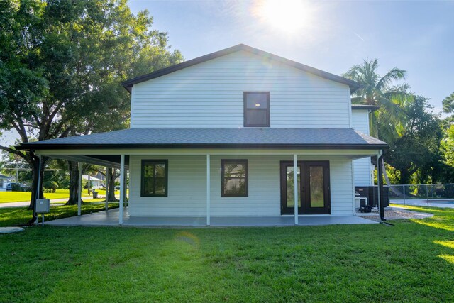 rear view of house featuring a yard