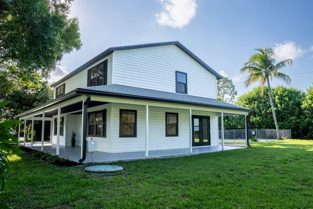 rear view of property with a yard and covered porch