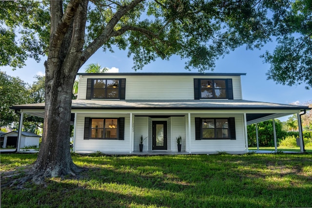 country-style home featuring a storage shed and a front yard