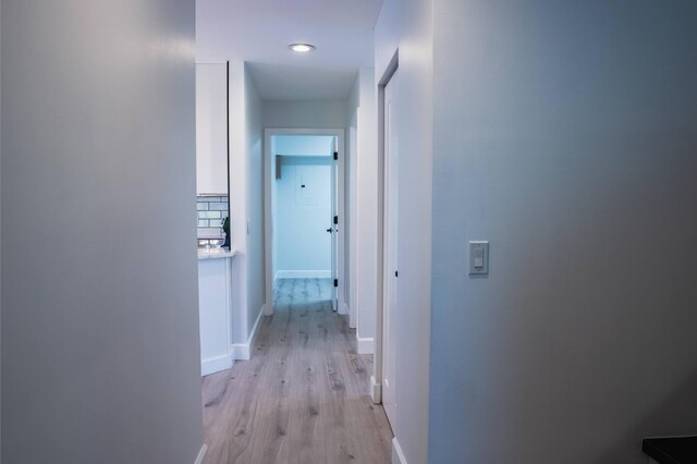 corridor featuring light hardwood / wood-style floors