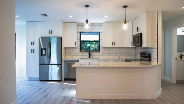 kitchen with sink, white cabinetry, light wood-type flooring, and stainless steel appliances