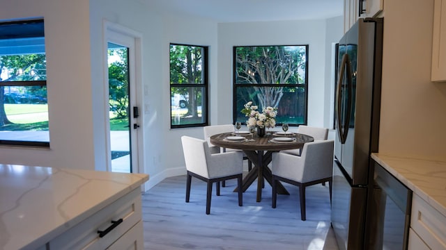 dining area with light hardwood / wood-style floors