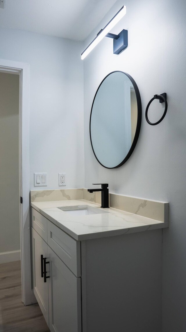 bathroom featuring hardwood / wood-style floors and vanity