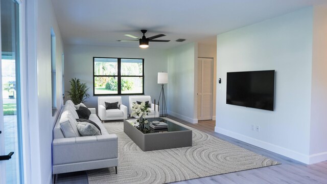 living room featuring hardwood / wood-style flooring and ceiling fan