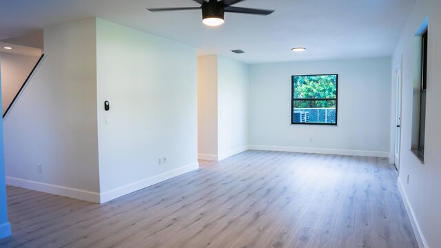 unfurnished room with ceiling fan and wood-type flooring