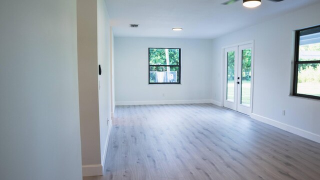 unfurnished room with hardwood / wood-style flooring and ceiling fan