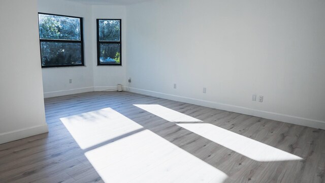 unfurnished room featuring hardwood / wood-style flooring