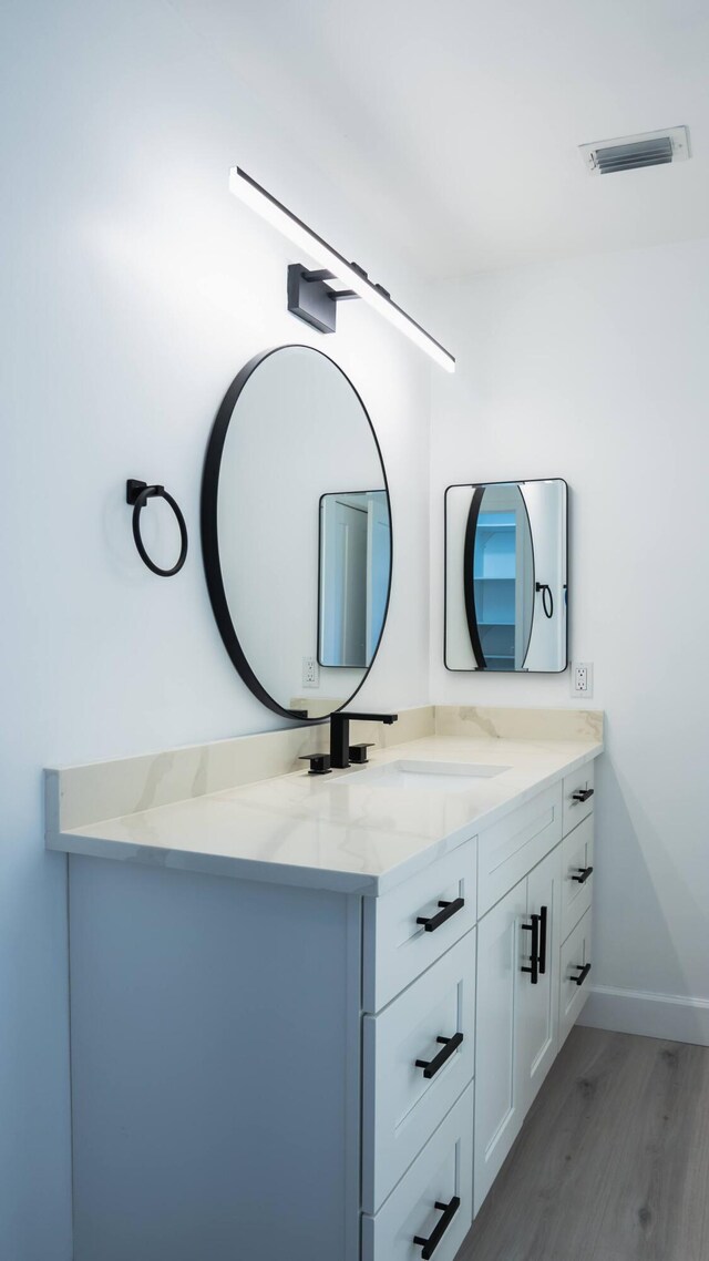 bathroom with vanity and hardwood / wood-style floors