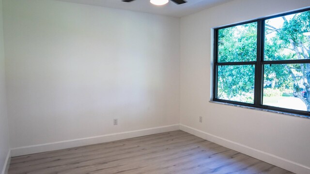 empty room featuring light wood-type flooring, ceiling fan, and plenty of natural light