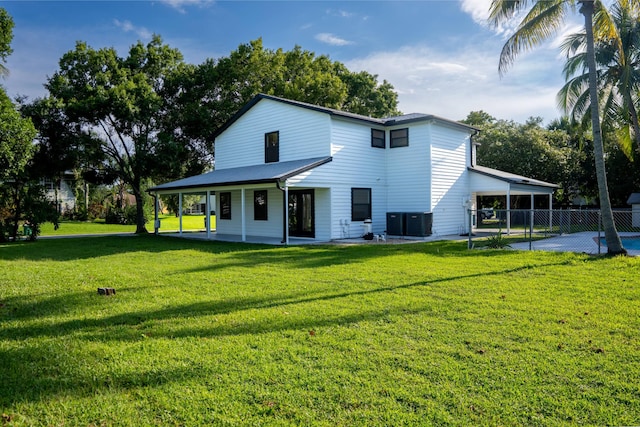 rear view of property featuring a lawn