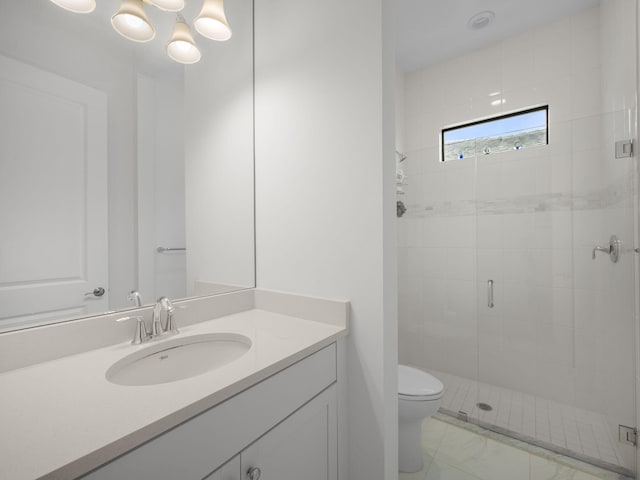 bathroom with vanity, toilet, and a shower with door