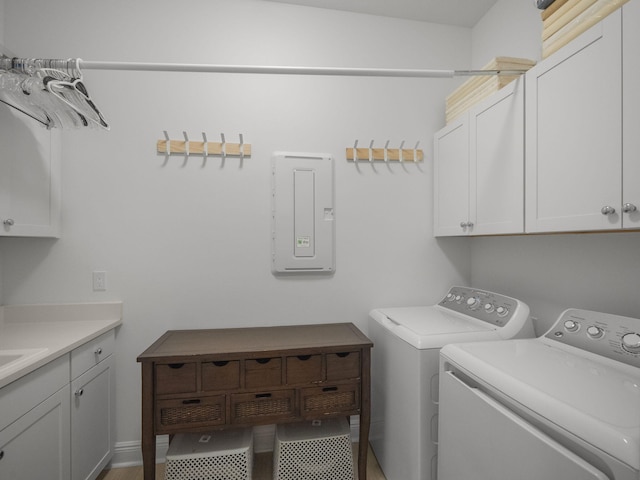 laundry area with washer and clothes dryer, cabinets, and tile patterned floors