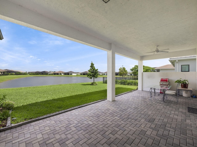 view of patio / terrace featuring ceiling fan and a water view