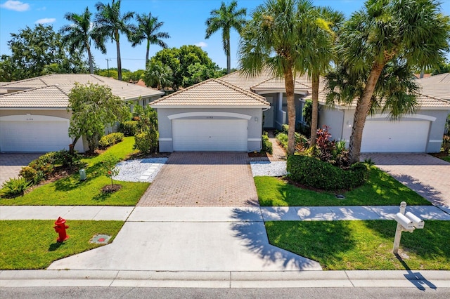 view of front of home with a garage and a front yard