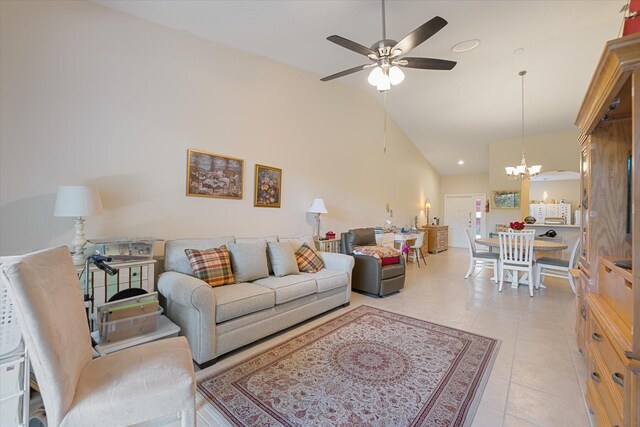 living room featuring ceiling fan with notable chandelier, light tile patterned floors, and high vaulted ceiling