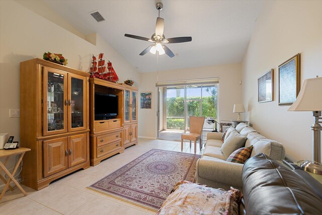 tiled living room featuring ceiling fan and vaulted ceiling