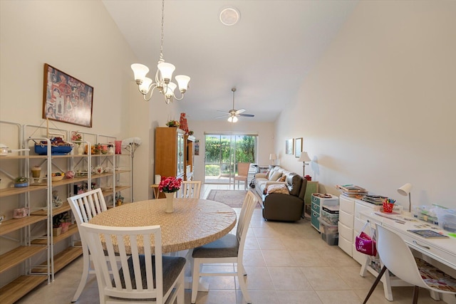 tiled dining space featuring high vaulted ceiling and ceiling fan with notable chandelier