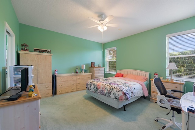 bedroom featuring ceiling fan and light carpet