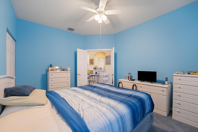 bedroom with ceiling fan and dark carpet