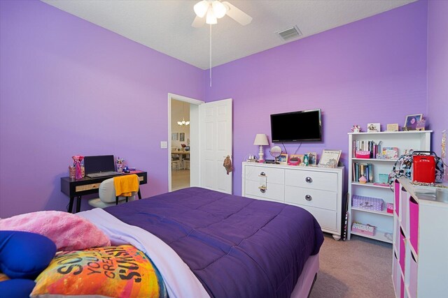 carpeted bedroom with a textured ceiling and ceiling fan